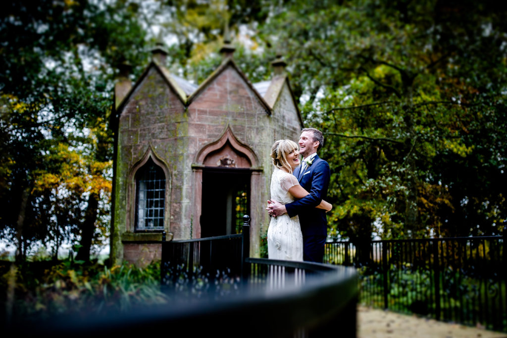 bride with a jenny packham wedding dress by the summer house at blaithwaite house