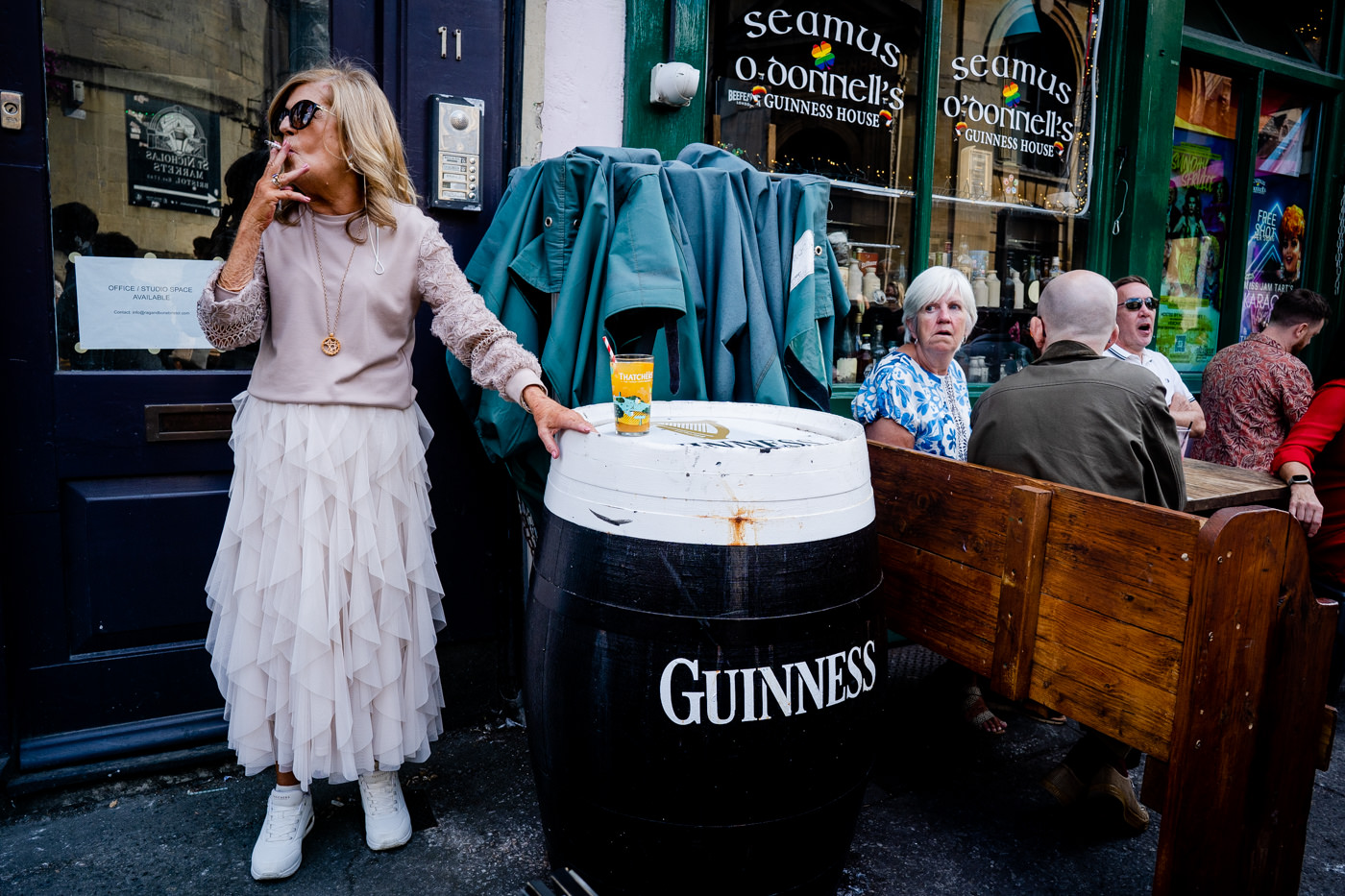 Wedding guests enjoying drinks outside Seamus O’Donnell’s pub in Bristol wedding ceremony.
