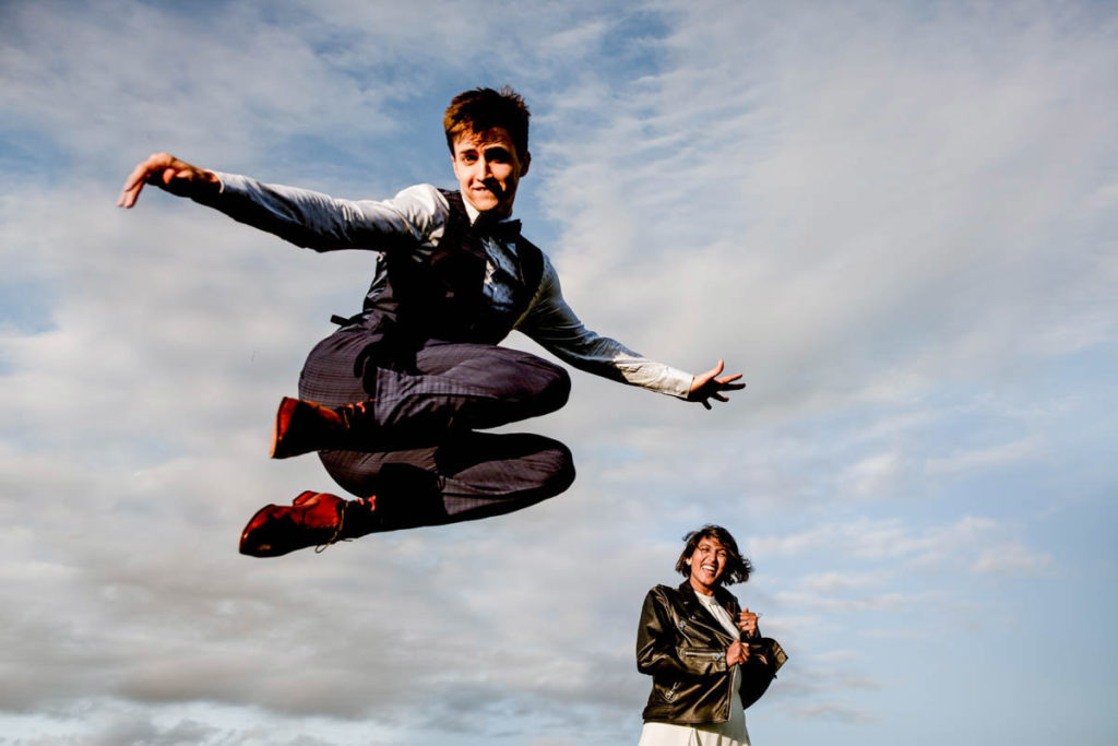 cool bride and groom wedding photo portrait at hidden river cabins wedding groom leaping in the air