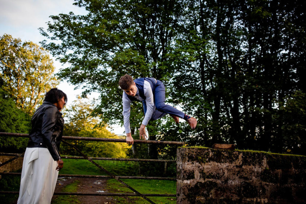 groom leaps gate at hidden river cabins wedding