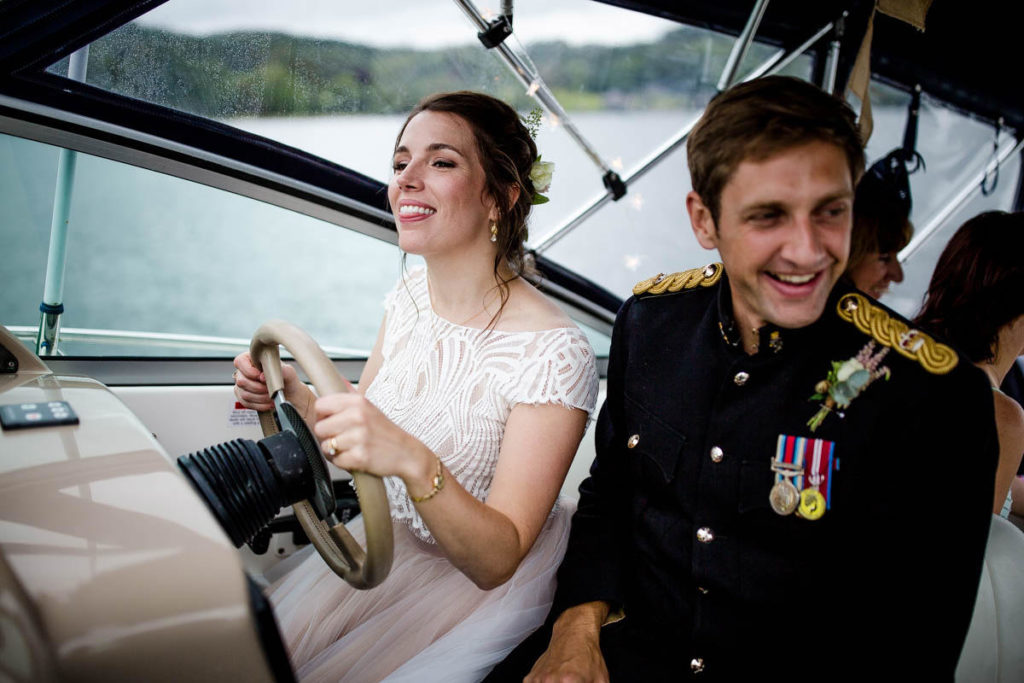 bride and groom sailing the boat  at storrs hall wedding