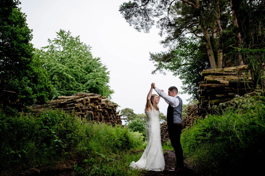Wedding photography portrait of couple by the logs at a high barn wedding in edenhall
