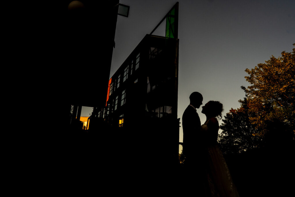 a wedding couple silhouetted at the paintworks