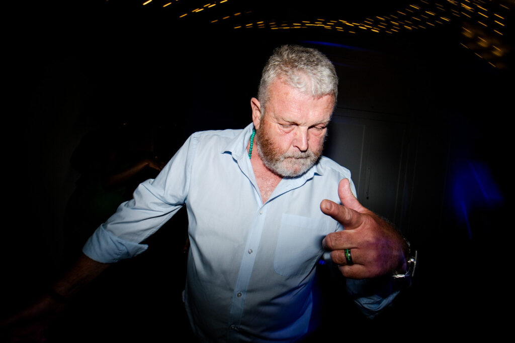 a drunk man throwing shapes on the dance floor