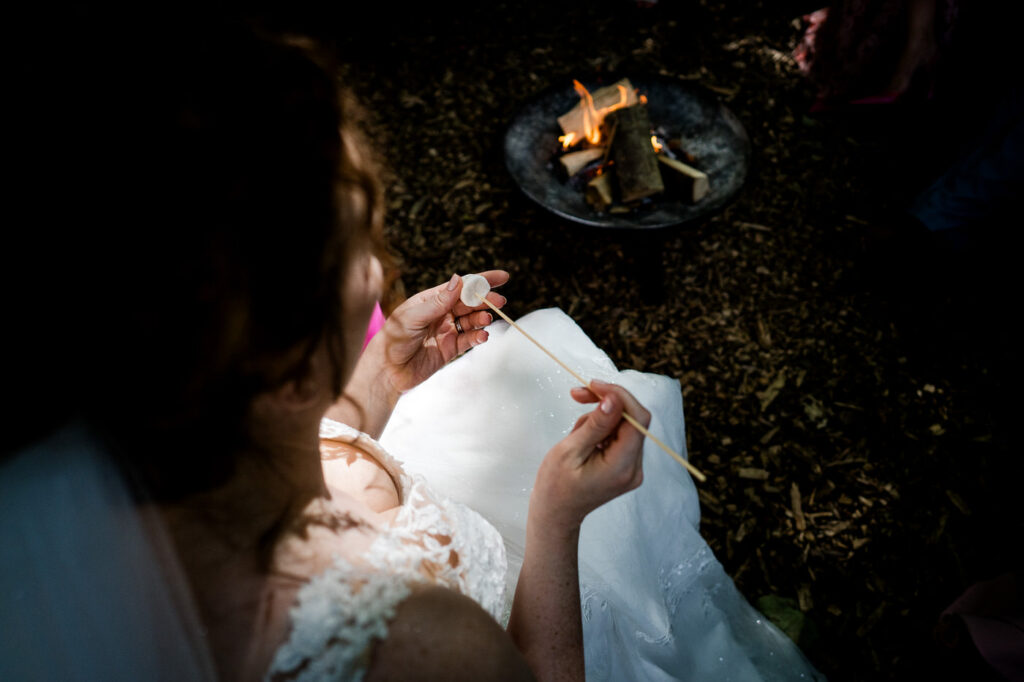 bride toasting marshmellows during her wedding at Arnos vale