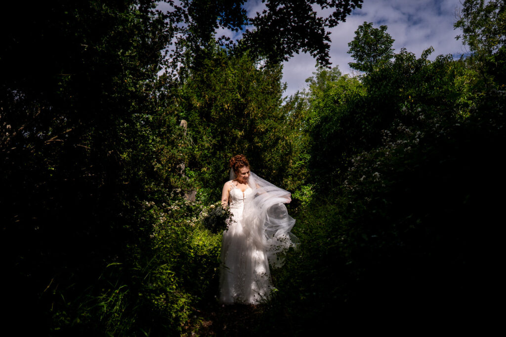 bride plays with veil in the middle of her wedding at arnos vale